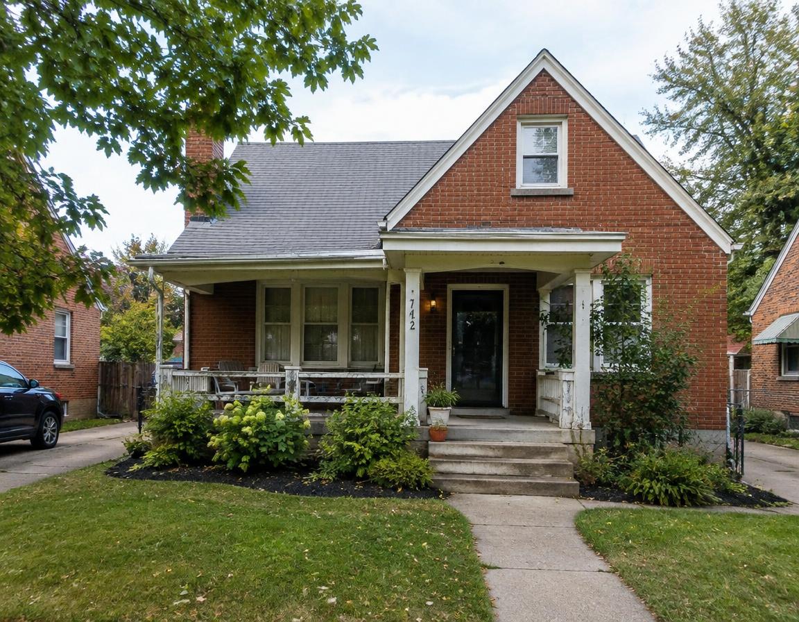 Older brick home with front porch, sold as-is
